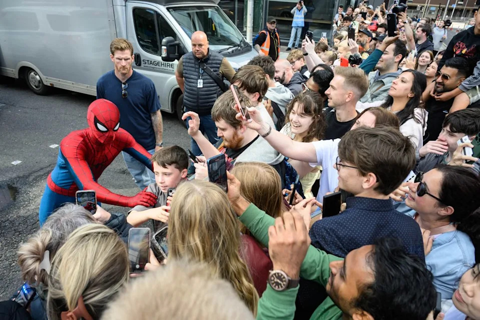Tom Holland, as Spider-Man, greets movie fans on set. Wattie Cheung / MEGA
