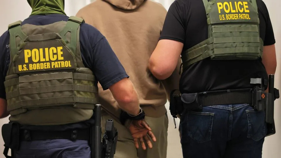 Federal agents detain a man after his July hearing at immigration court in New York City. Trump says the new census won't count undocumented immigrants. - Michael M. Santiago/Getty Images/File