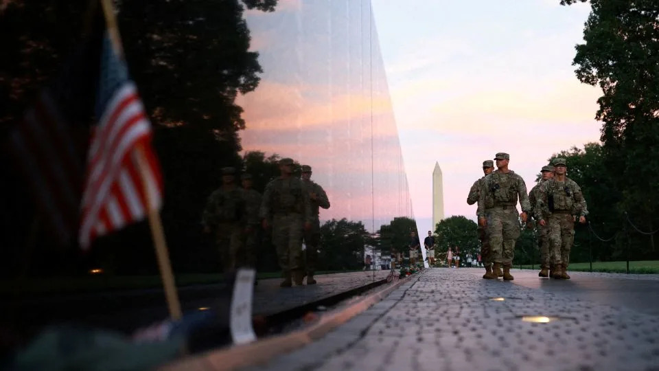 Members of the National Guard walk through the National Mall on Saturday in Washington, DC. - Jose Luis Gonzalez/Retuers