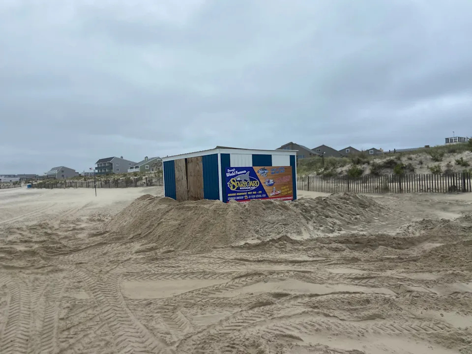 A beach shed is fortified with sand at low tide in Dewey Beach on Aug. 21, 2025.