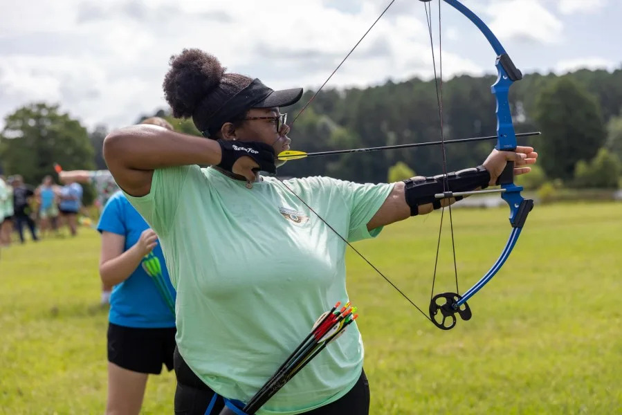 Mississippi 4-H participant using a bow (Courtesy: Ellen Graves, MSU Extension Service)