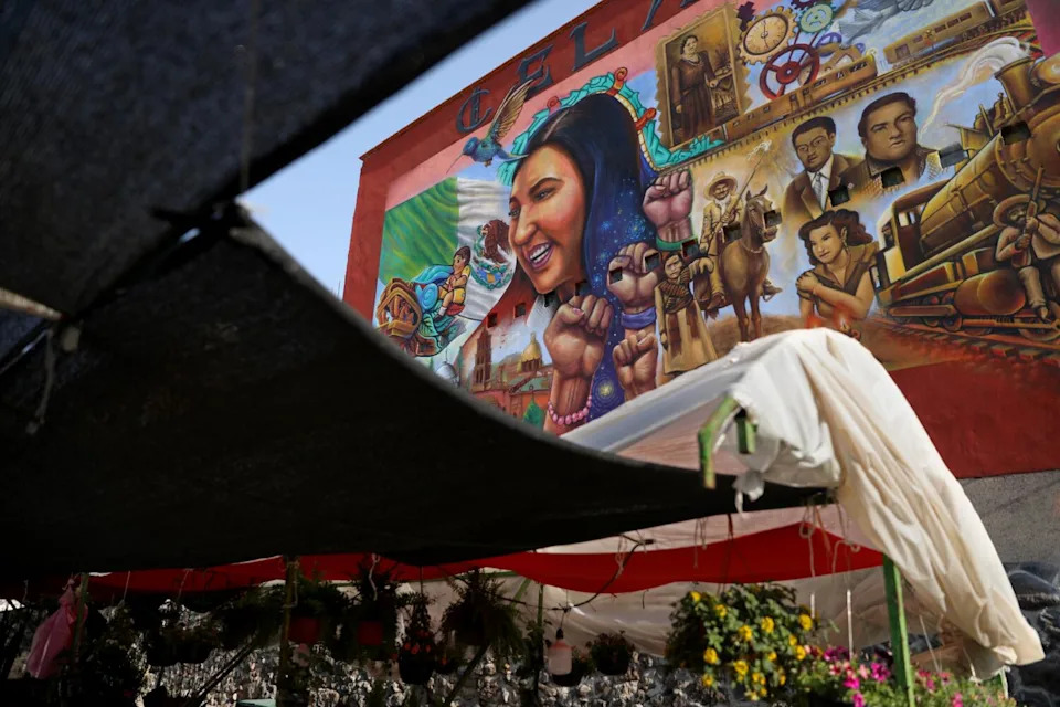 Gisela Gaytan's portrait is part of a colorful mural.