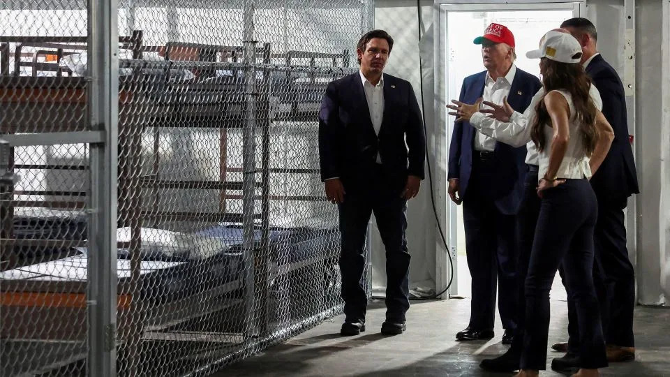 President Donald Trump, Florida Gov. Ron DeSantis and Homeland Security Secretary Kristi Noem visit a temporary migrant detention center informally known as "Alligator Alcatraz" in Ochopee, Florida, on July 1, 2025. - Evelyn Hockstein/Reuters