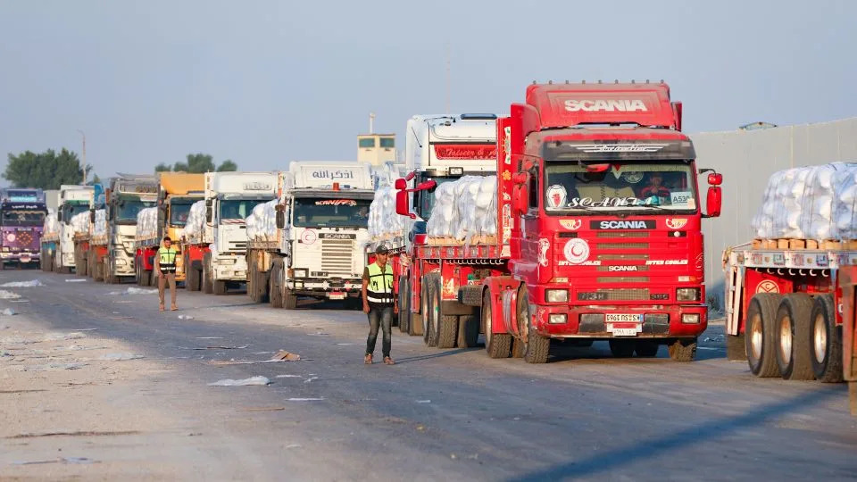 A convoy of aid trucks on the Egyptian side of the Rafah crossing with the Gaza Strip awaits permission to drive toward the besieged Palestinian territory on Sunday. - STR/AFP/Getty Images