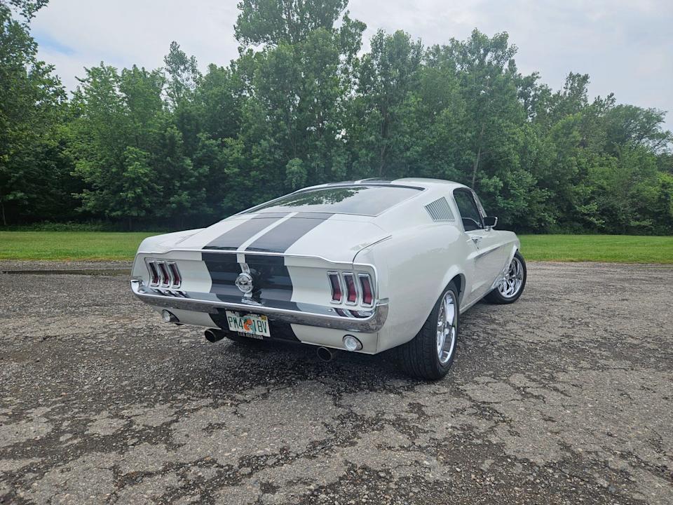 ecd built ford mustang with black racing stripes parked outdoors