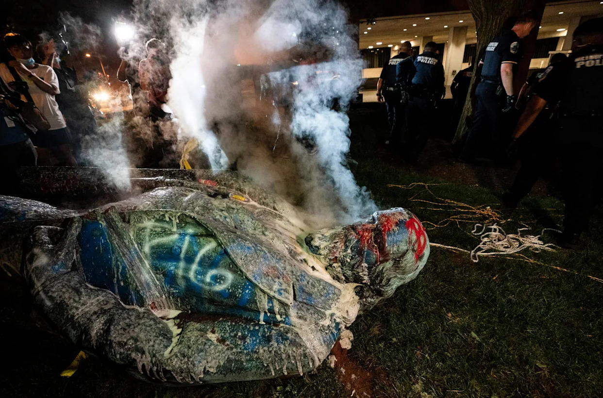 <span>Police extinguish the burning statue of Albert Pike in Washington DC on 19 June 2020.</span><span>Photograph: Evelyn Hockstein for The Washington Post via Getty Images</span>