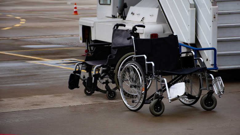 Two wheelchairs on the tarmac at an airport
