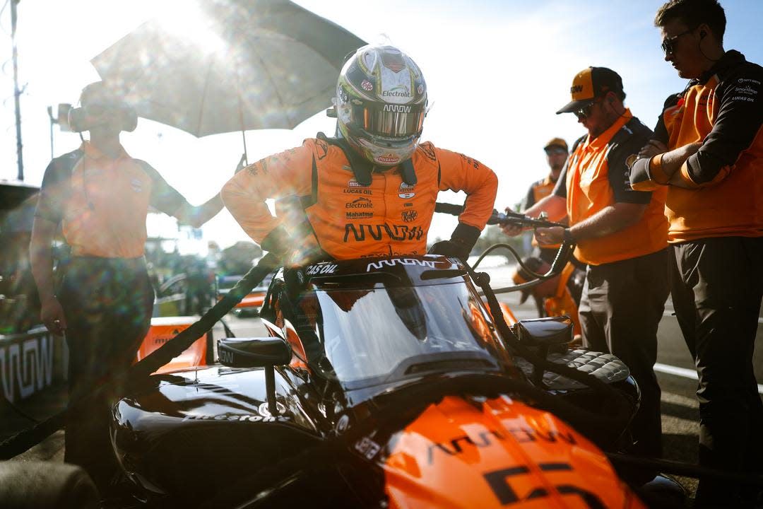 pato o&#39;ward driver preparing in a pit area with supporting crew