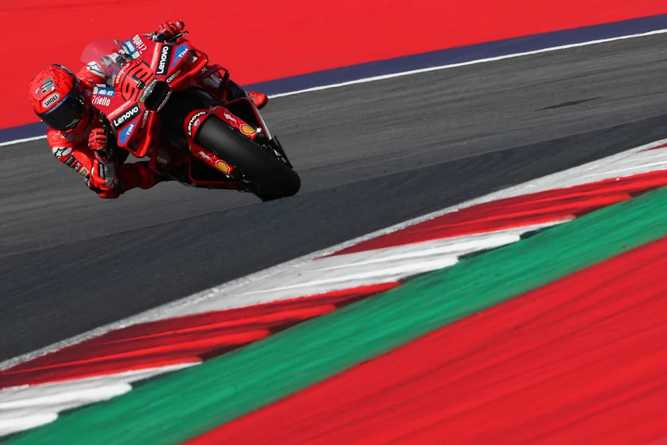 A motorcycle racer leans into a tight turn.