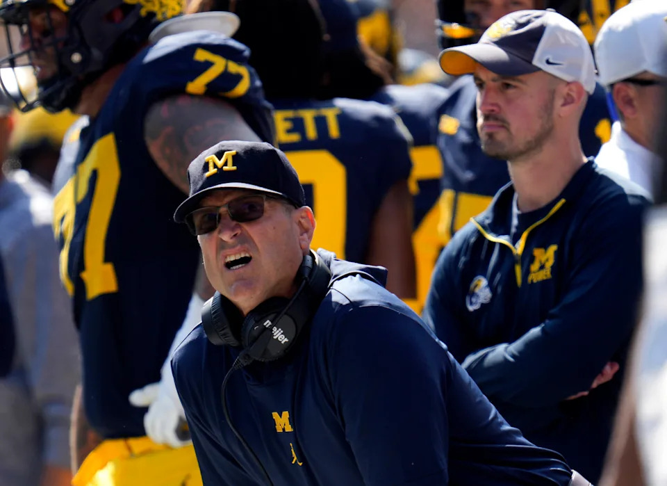 FILE - Michigan head coach Jim Harbaugh, front left, watches against Rutgers as analytics assistant Connor Stalions, right, looks on during an NCAA college football game in Ann Arbor, Mich., Sept. 23, 2023. Stalions is set to share his side of the story from an alleged sign-stealing scheme within Michigan’s football team before it went on to win the national championship. (AP Photo/Paul Sancya, File)