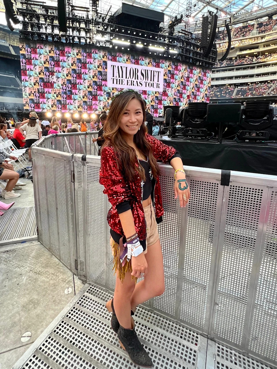 Kayla Wong, the "Data Swiftie" and creator of @headfirstfearless, poses in front of the Eras Tour stage.