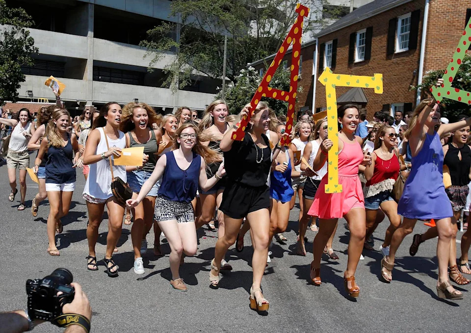 Girls run to their prospective sorority houses after opening their bids in Bryant-Denny Stadium in Tuscaloosa, Ala. on Saturday Aug. 16, 2014. Approximately 2,300 girls participated in the University of Alabama's fall recruitment.  staff photo | Erin Nelson