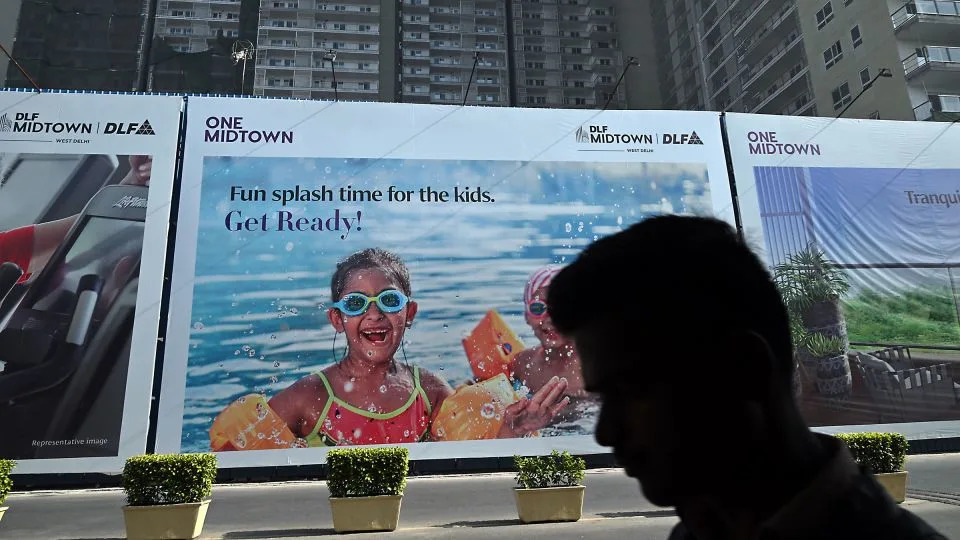 English-language signage appears at the construction site of a new residential building in New Delhi, in December 2023. - Prakash Singh/Bloomberg/Getty Images