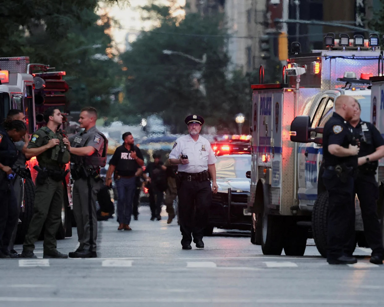 <span>Police officers at the scene in Manhattan on Monday evening.</span><span>Photograph: Jeenah Moon/Reuters</span>