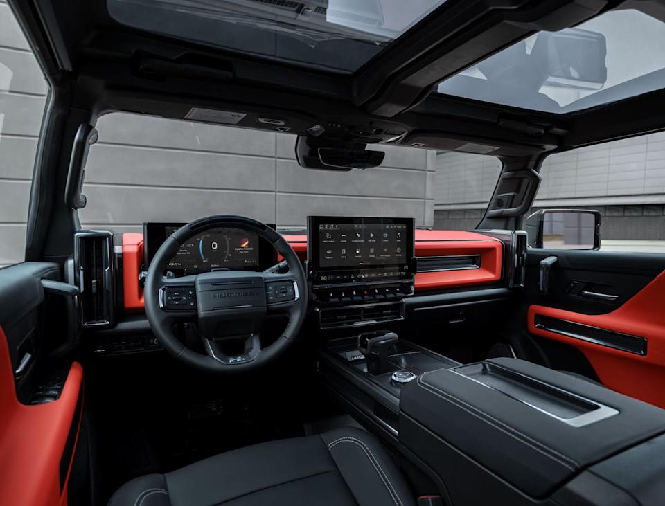 front facing view of the interior of the 2026 gmc hummer ev carbon fiber edition pickup. velocity ember interior color shown.