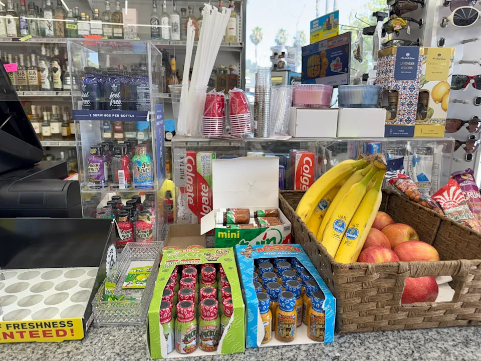 Drinks containing kratom are seen in a case at the checkout counter at a liquor market in Los Angeles, alongside bananas, toothpaste and 5-hour Energy.