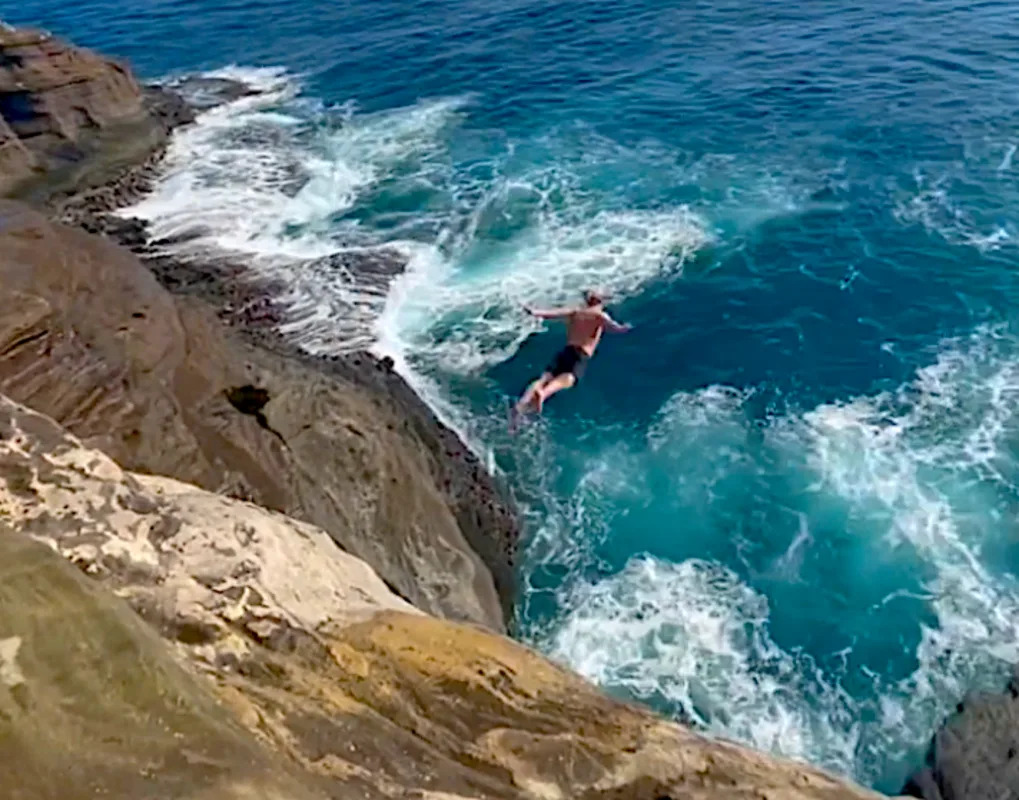 Maniac Jumps 70ft Hawaii Cliff, Near-Death Experience (Video)