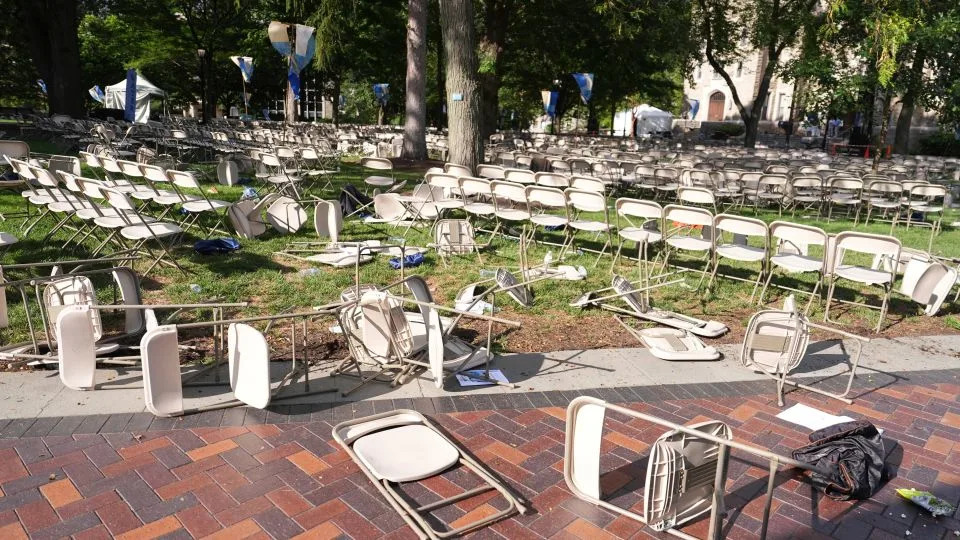 Toppled chairs are scattered on a lawn at Villanova University, where an active shooter was reported on August 21. - Matt Slocum/AP