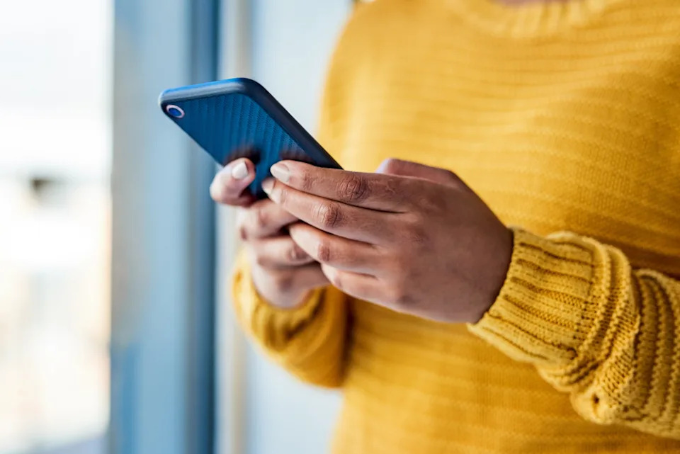 A woman using a mobile phone indoors