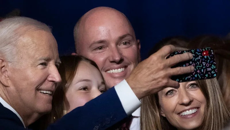 President Joe Biden takes a photo with Emma Kate Cox, Gov. Spencer Cox and first lady Abby Cox after speaking at the George E. Wahlen Department of Veterans Affairs Medical Center in Salt Lake City on Thursday, Aug. 10, 2023. The president of the United States was in Utah seeking support for his policies.