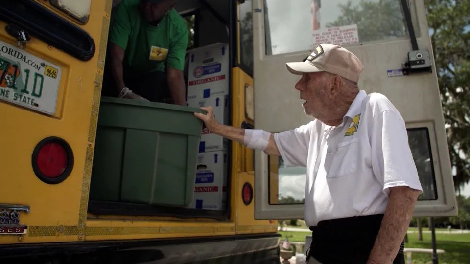 Bill Brown helps with a food delivery along the Children's Table weekly bus route. - CNN
