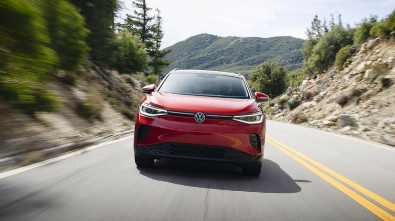 a head-on shot of a red ID.4 driving on a mountain road