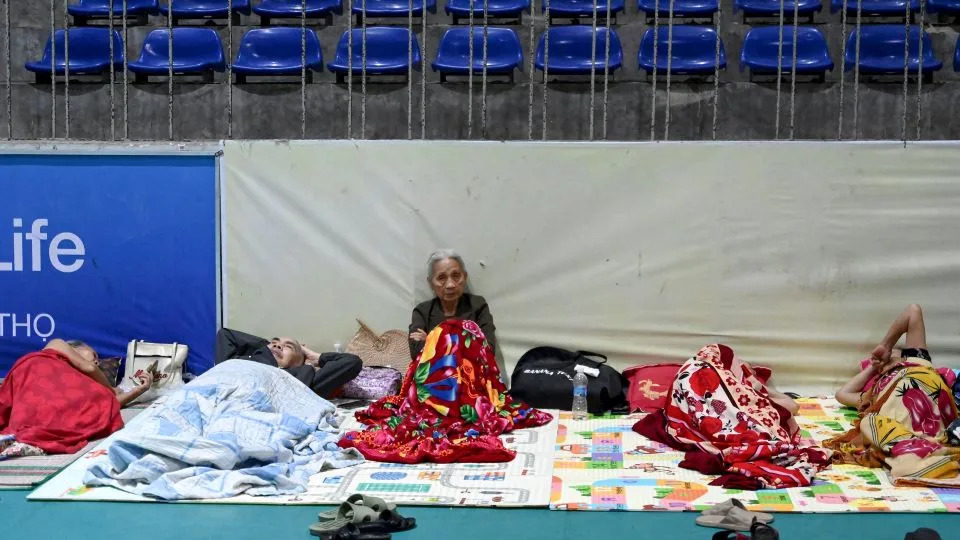 People take shelter inside the Nghe An Provincial Gymnasium in Vinh city, Nghe An province on August 25, 2025, before Typhoon Kajiki makes landfall in Vietnam. - Nhac Nguyen/AFP/Getty Images