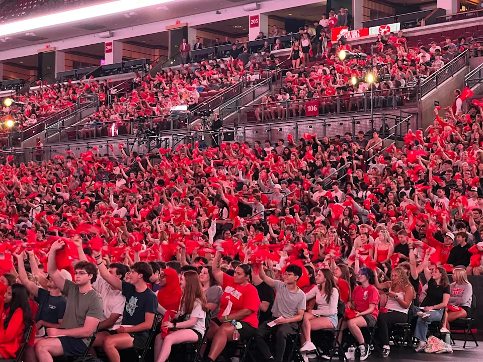 Ohio State University students wave red rally towels during Convocation, the university's official welcome to new students, on Aug. 25, 2025, at the Schottenstein Center. Buckeyes Head Coach Ryan Day told students at the event to show up loud and proud for the Buckeyes at the team's home opener against Texas.