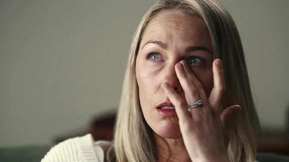 A close-up of Denise Huskins crying and rubbing her eye.