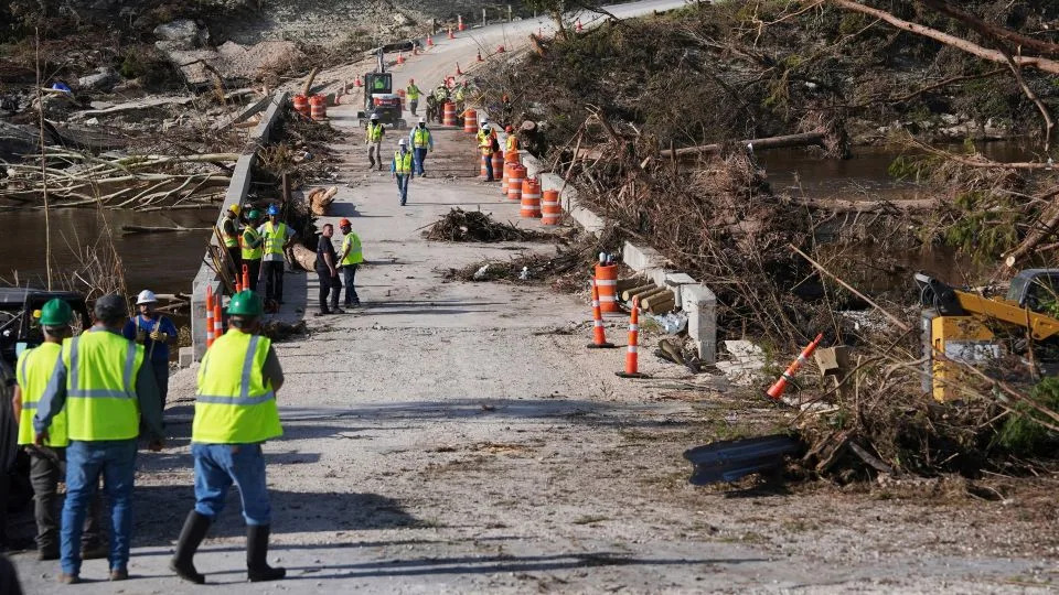 Crews work to clear debris July 10 on the Cade Loop Bridge after flooding along the Guadalupe River in Ingram, Texas. - Joshua A. Bickel/AP