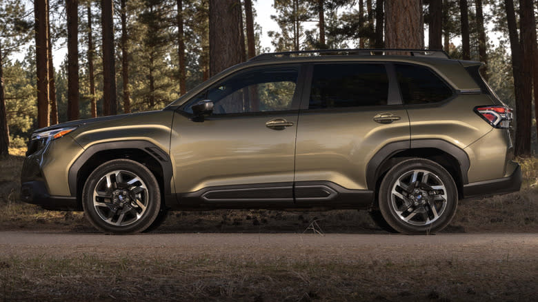 A copper-colored 2025 Subaru Forester in a forest