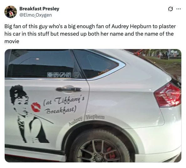 Car with Audrey Hepburn decal reading "(at Tiffany's Breakfast)" and "Audrey Hepbrun," misspelling both her name and the movie title