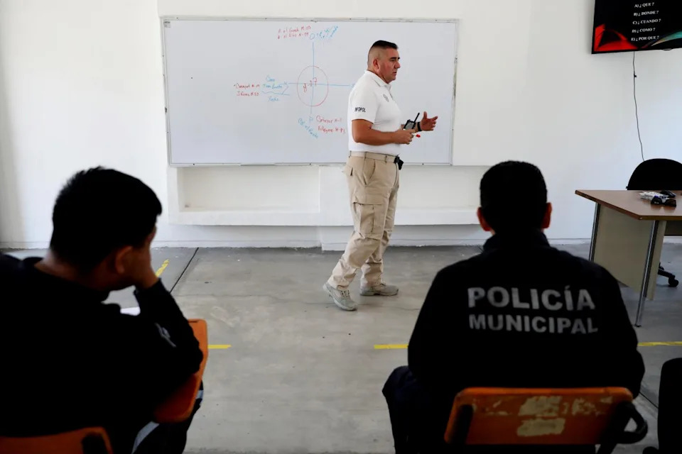 An instructor in front of a classroom.