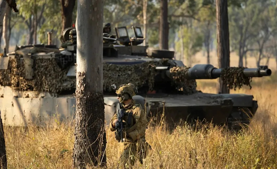 An Australian Army M1A1 Abrams tank from the 2nd Cavalry Regiment and an Australian Army soldier from the 3rd Battalion, The Royal Australian Regiment during Exercise Brolga Sprint 24 at Townsville Field Training Area, Queensland, in June 2024. Australian Department of Defense TPR Dana Millington