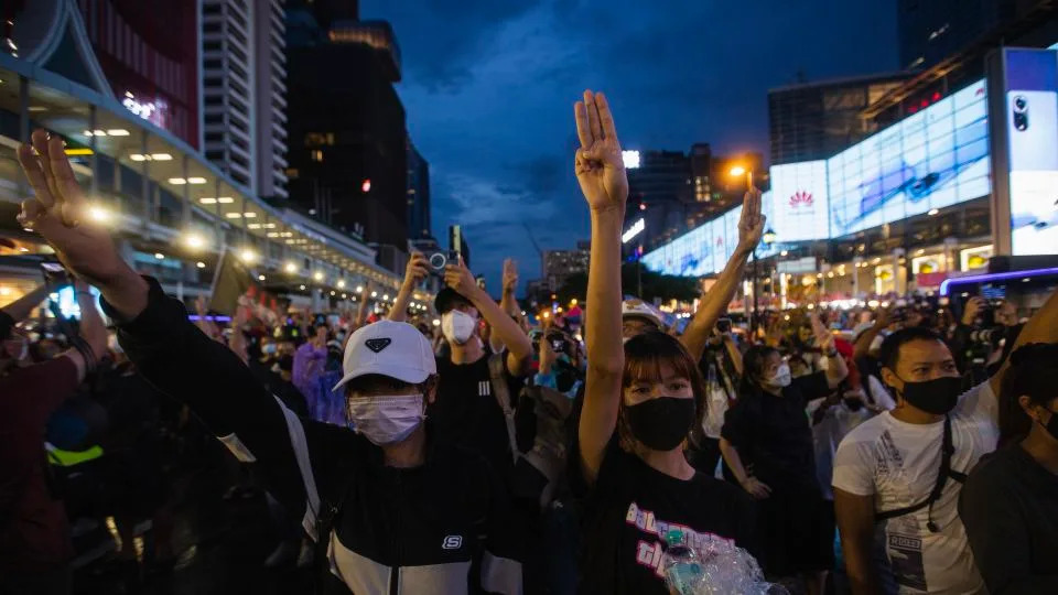 Pro-democracy protesters raise three finger salute during the demonstration demanding the abolition of the lese majeste law and monarchy reform in Bangkok, Thailand on October 31, 2021. - Varuth Pongsapipatt/SOPA/Sipa