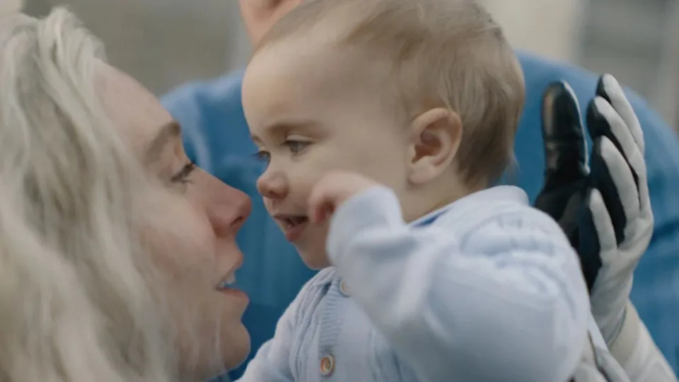 Sue Storm holds her baby Franklin Reed close to her face with a smile