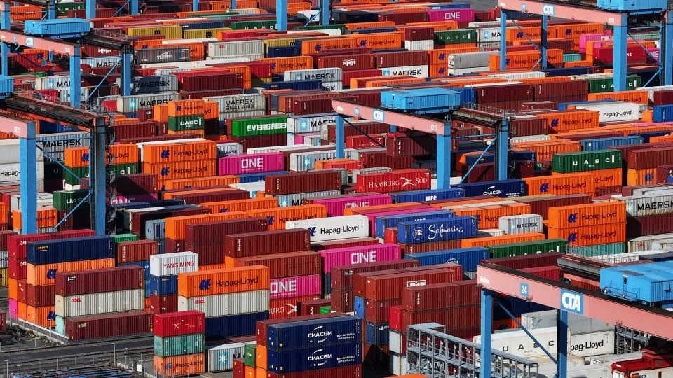 Traversing cranes move shipping containers stacked in Hamburg Port in Hamburg, Germany, on April 15. - Sean Gallup/Getty Images