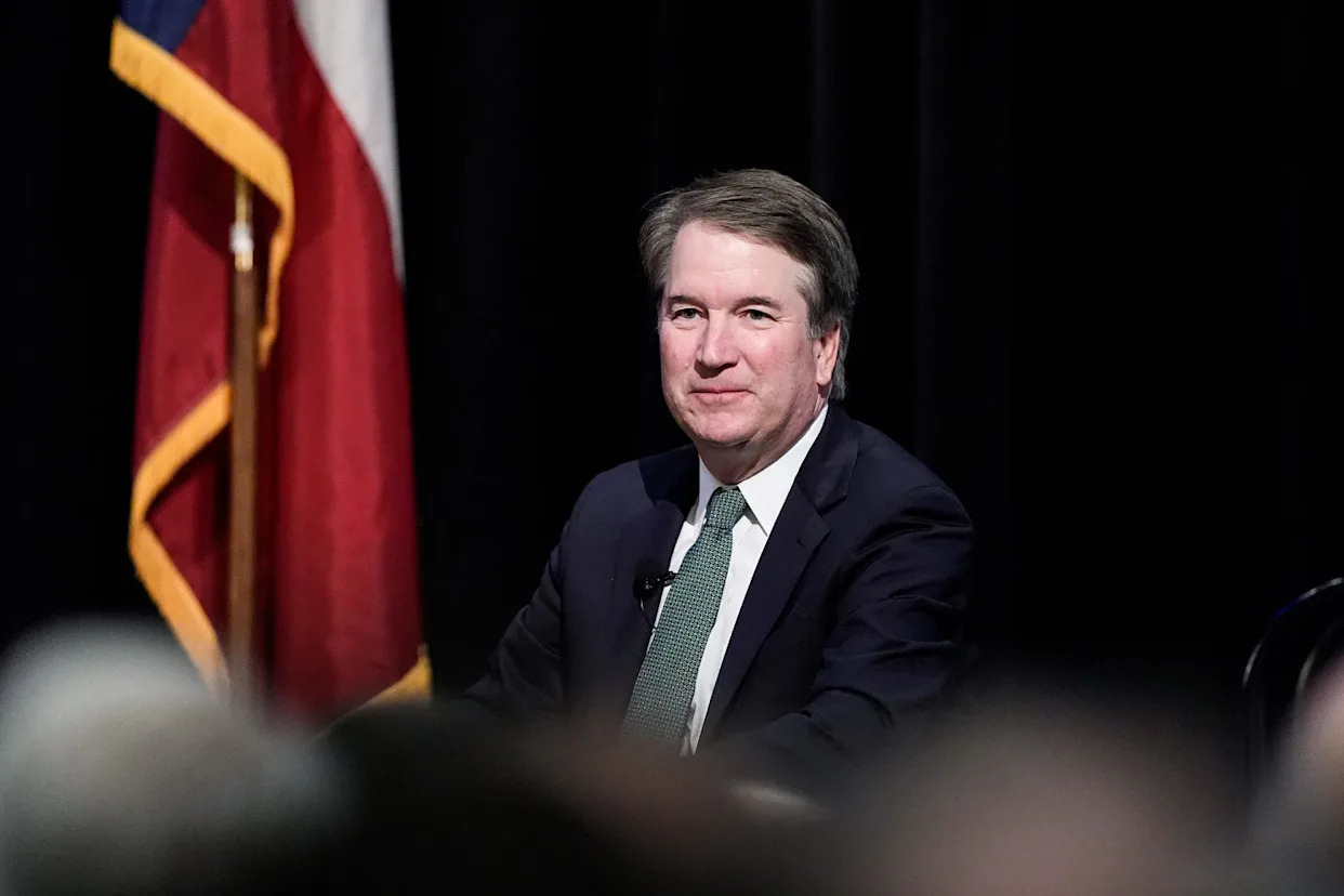 Brett Kavanaugh seated on stage in front of an audience (Eric Gay / AP)