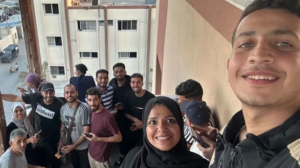 A group of journalists works from the balcony at Nasser Hospital on June 12, including two of the victims of Monday's attacks, Mariam Abu Dagga and Moath Abu Taha - Courtesy Mohammad Salama