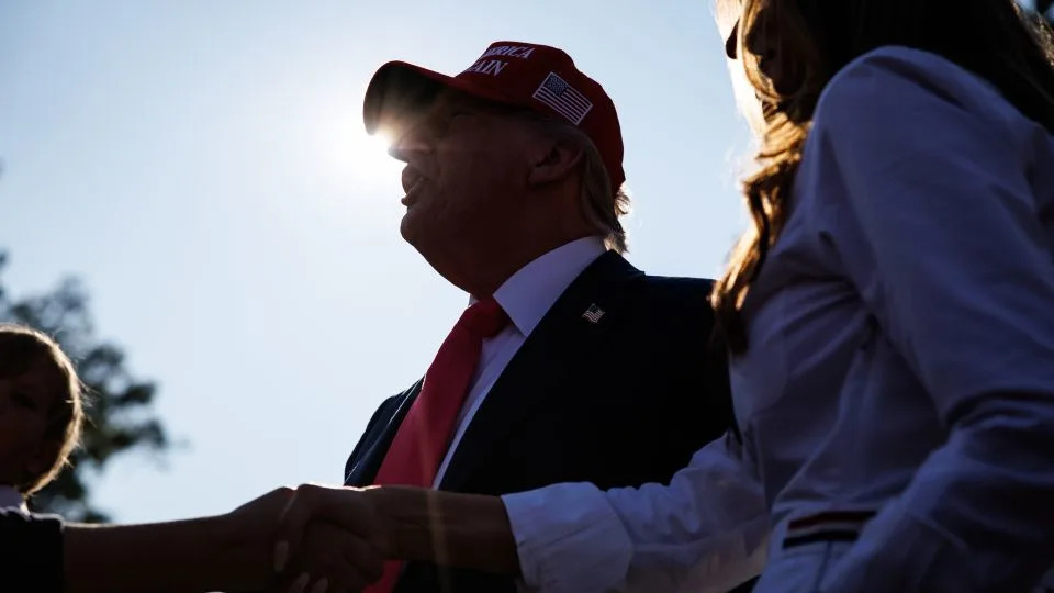 President Donald Trump and first lady Melania Trump greet guests during an Independence Day military family picnic at the White House on July 4. - Samuel Corum/Getty Images