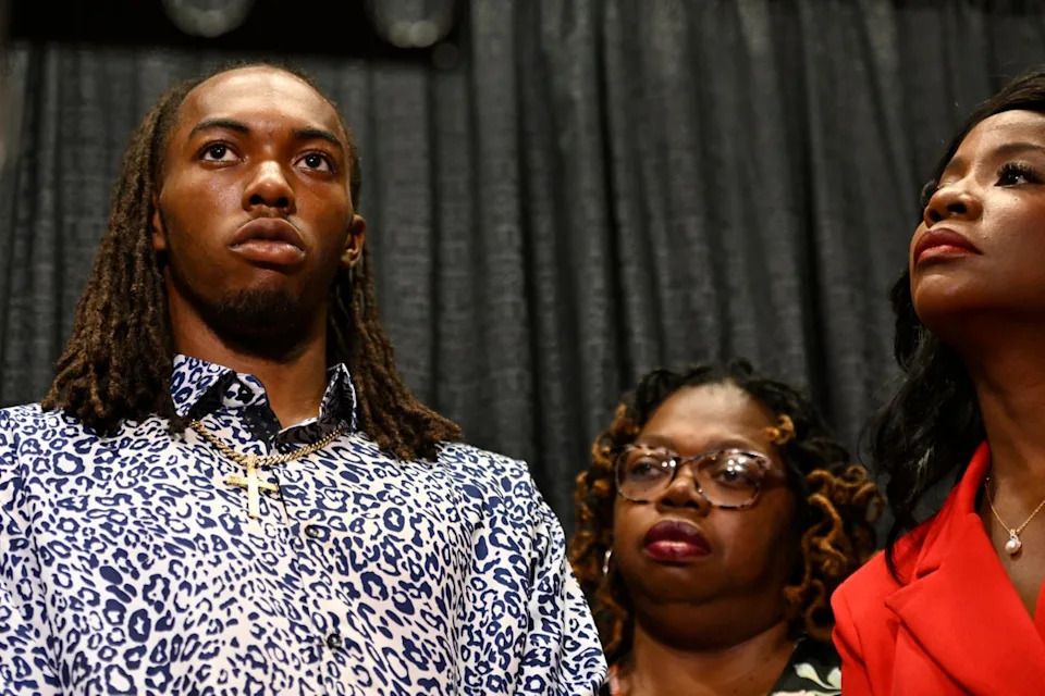 William McNeil Jr. with his mother Latoya Solomon, center, and attorney Sue-Ann Robinson, right (AP)