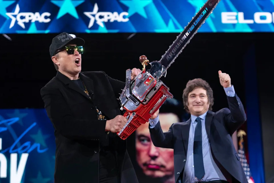 Elon Musk, left, receives a chainsaw from Argentina's President Javier Milei