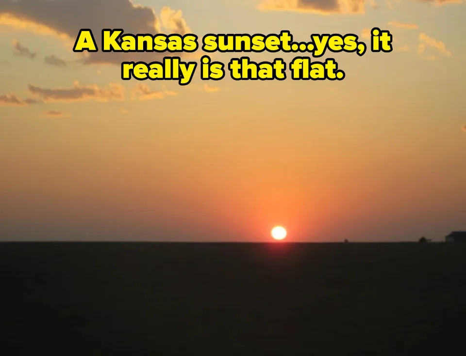 Sunset on the horizon with scattered clouds in the sky, creating a serene and tranquil scene. Caption: "A Kansas sunset...yes, it really is that flat"