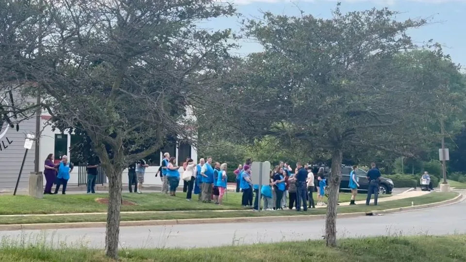 Police officers speak to Walmart employees outside a Walmart store, where a stabbing incident occurred, in Traverse City, Michigan, on July 26, 2025. - Jerome Hartl/UGC/Reuters