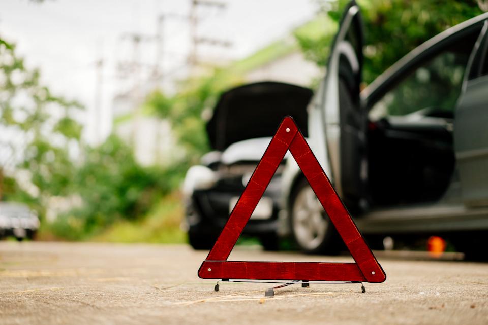 A roadside warning triangle marking a car accidentGetty