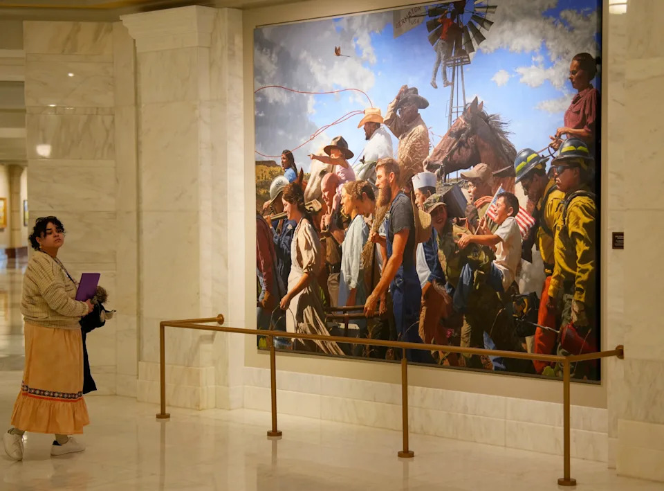 A woman pauses by a mural, "Labor Omnia Vincit" by Lucas Simmons, on the ground floor of the state Capitol. The Oklahoma Arts Council is taking cost-cutting measures, including suspending its program of rotating exhibitions in the Oklahoma State Capitol galleries.