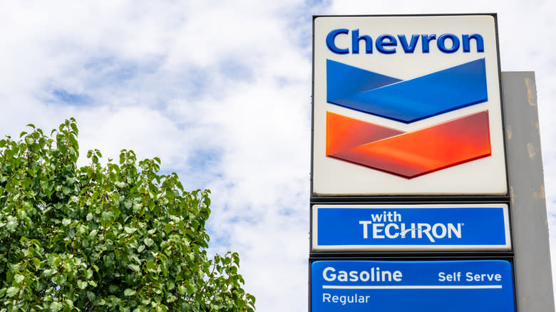 Chevron gas station prices are seen on July 18, 2025 in Austin, Texas. Chevron has completed its $53 billion acquisition of Hess after a tense feud with Exxon Mobil over a rival bid last year after.