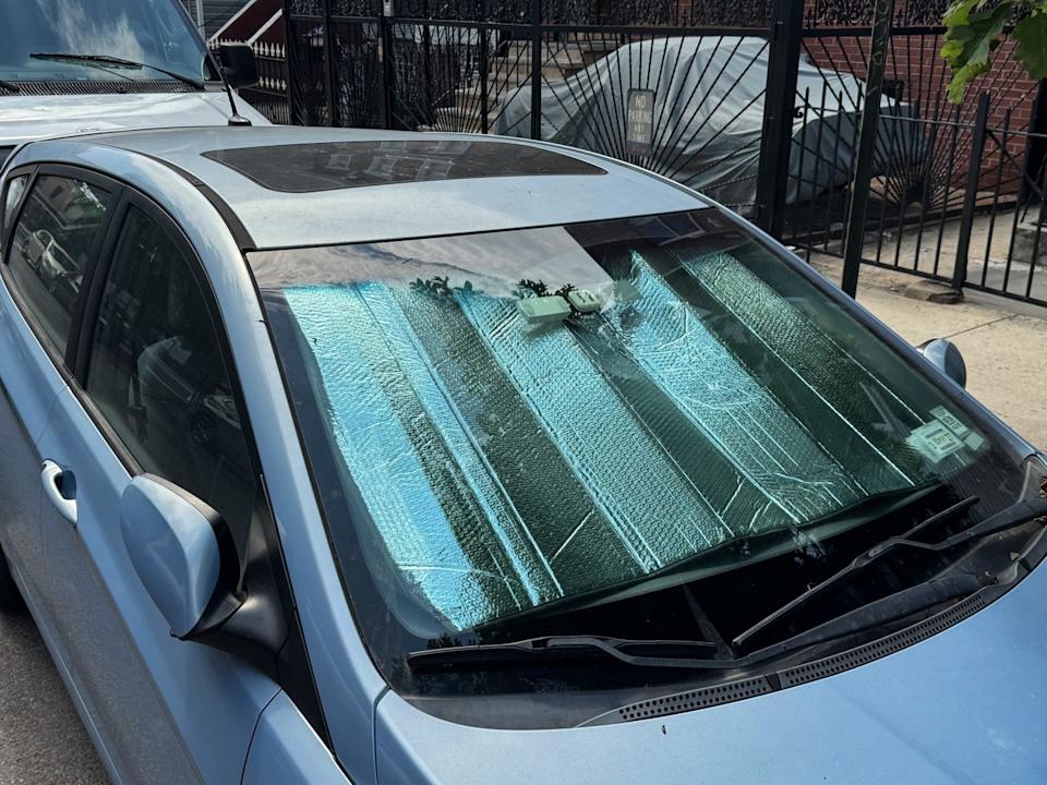 car with a sun shade set up inside of its windshield
