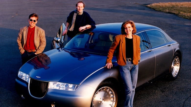 Ghia designer Moray Callum, David Wilkie, and Sally Wilson, from left, stand with the silver/gray Aston Martin Lagonda Vignale prototype
