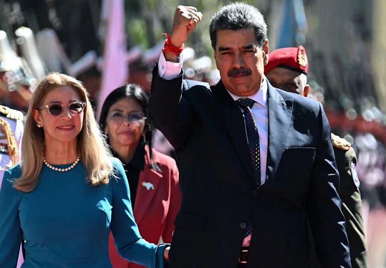 Venezuela's President Nicolas Maduro gestures next to first lady Cilia Flores on arrival at the Capitoli, house of the National Assembly, for the presidential inauguration, in Caracas, Jan. 10, 2025.  / Credit: FEDERICO PARRA/AFP/Getty